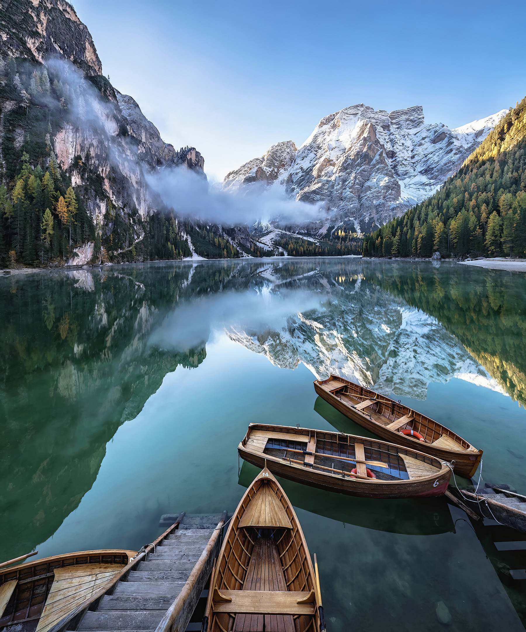 Boats on a lake with mountains in the background Boats on a lake with mountains in the background
