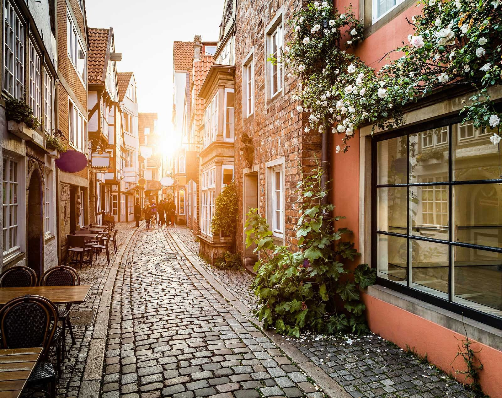 Street with buildings and tables and chairs