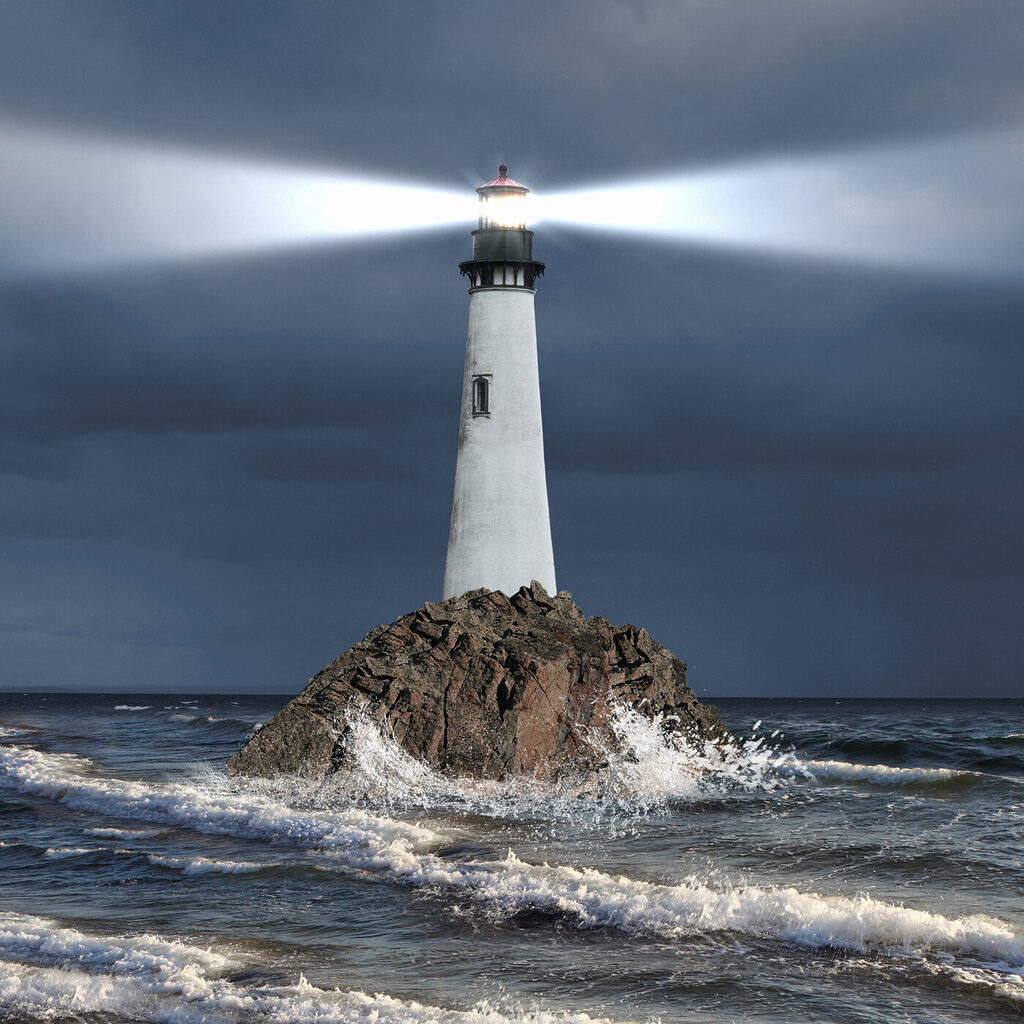 A lighthouse on a rock in the ocean