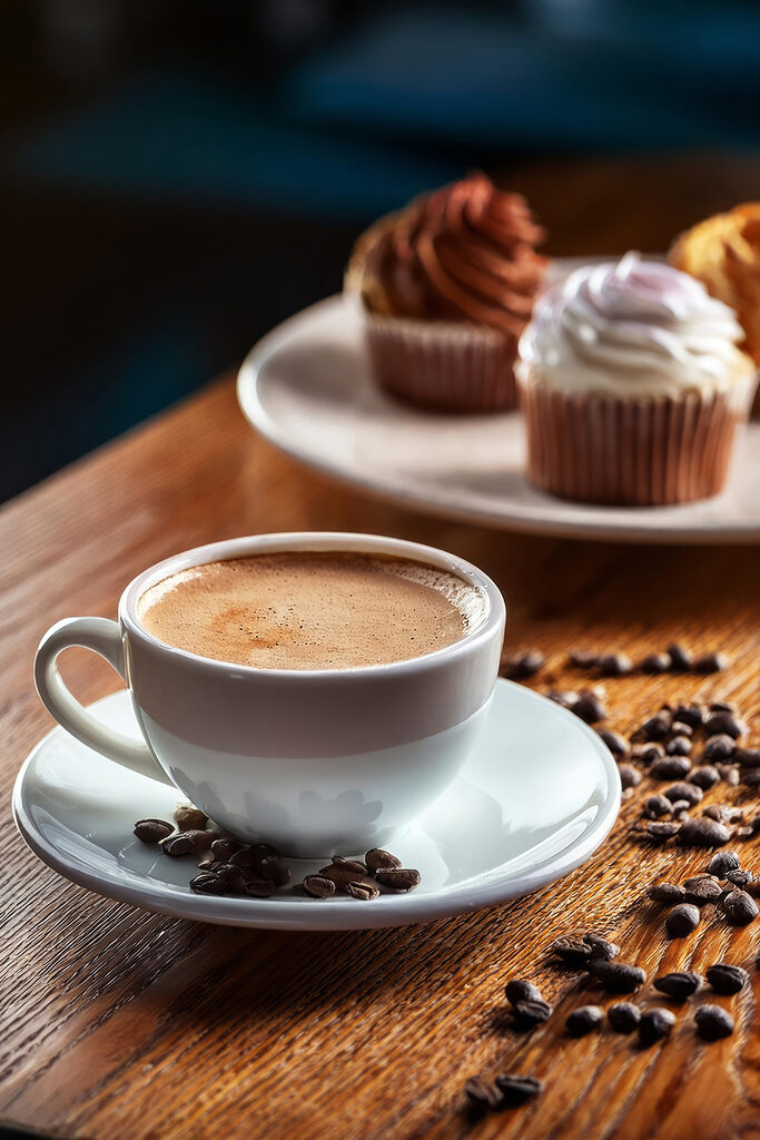 Cup of coffee and cupcakes on a table Cup of coffee and cupcakes on a table