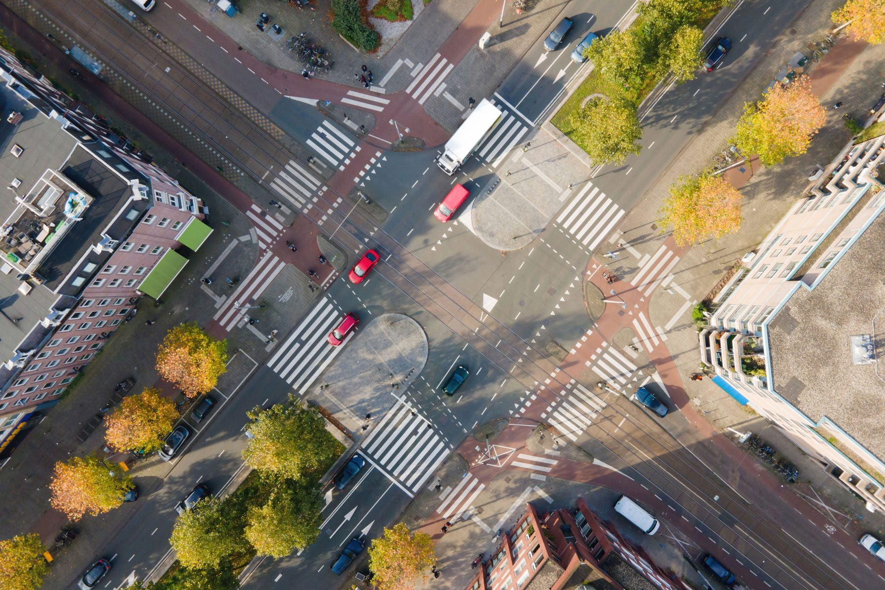 Aerial view of a street intersection with cars and buildings