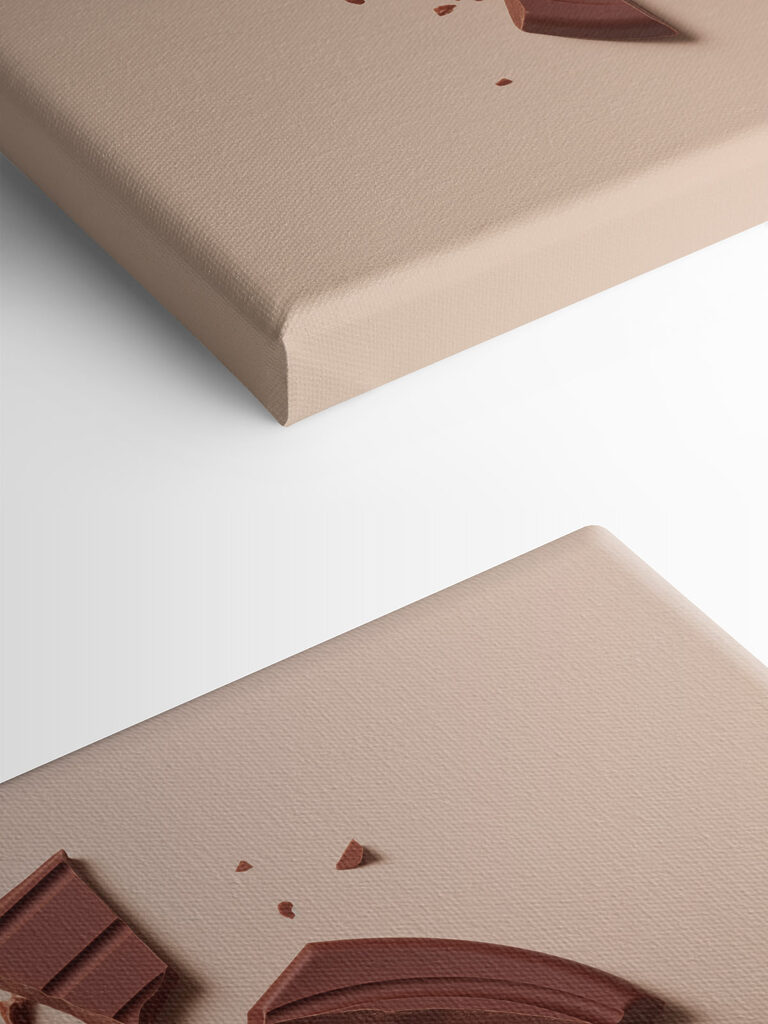 Broken chocolate bar on a pink surface Broken chocolate bar on a pink surface