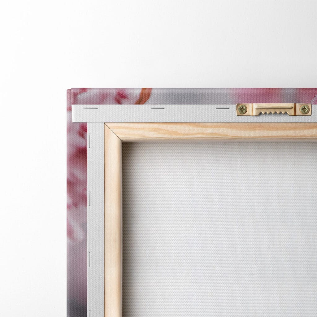 An owl in a tree with pink flowers