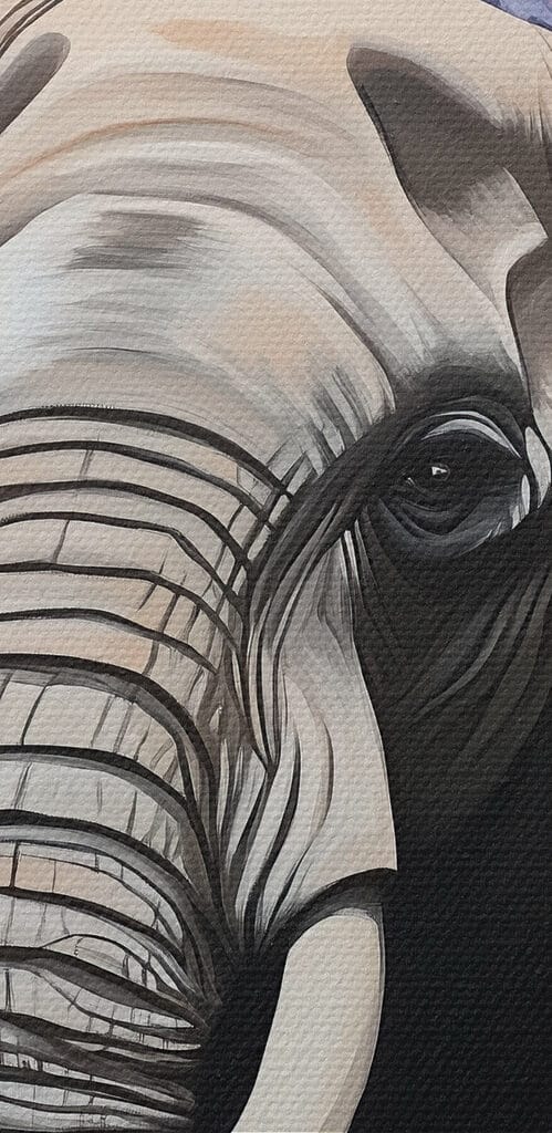 An elephant with tusks in a flower garden