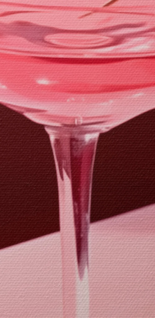 Glass with pink liquid and two cherries on it Glass with pink liquid and two cherries on it
