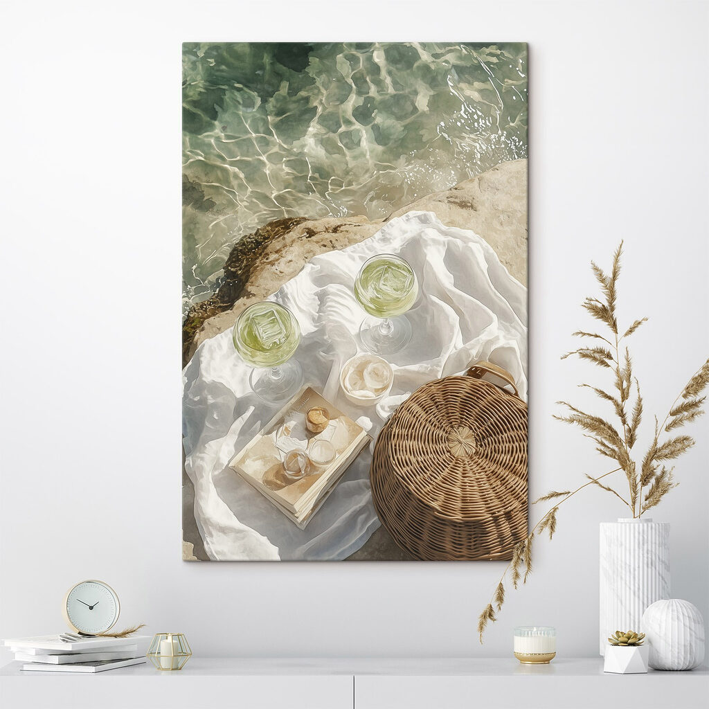 Picnic basket and glasses of wine on a rock by water Picnic basket and glasses of wine on a rock by water