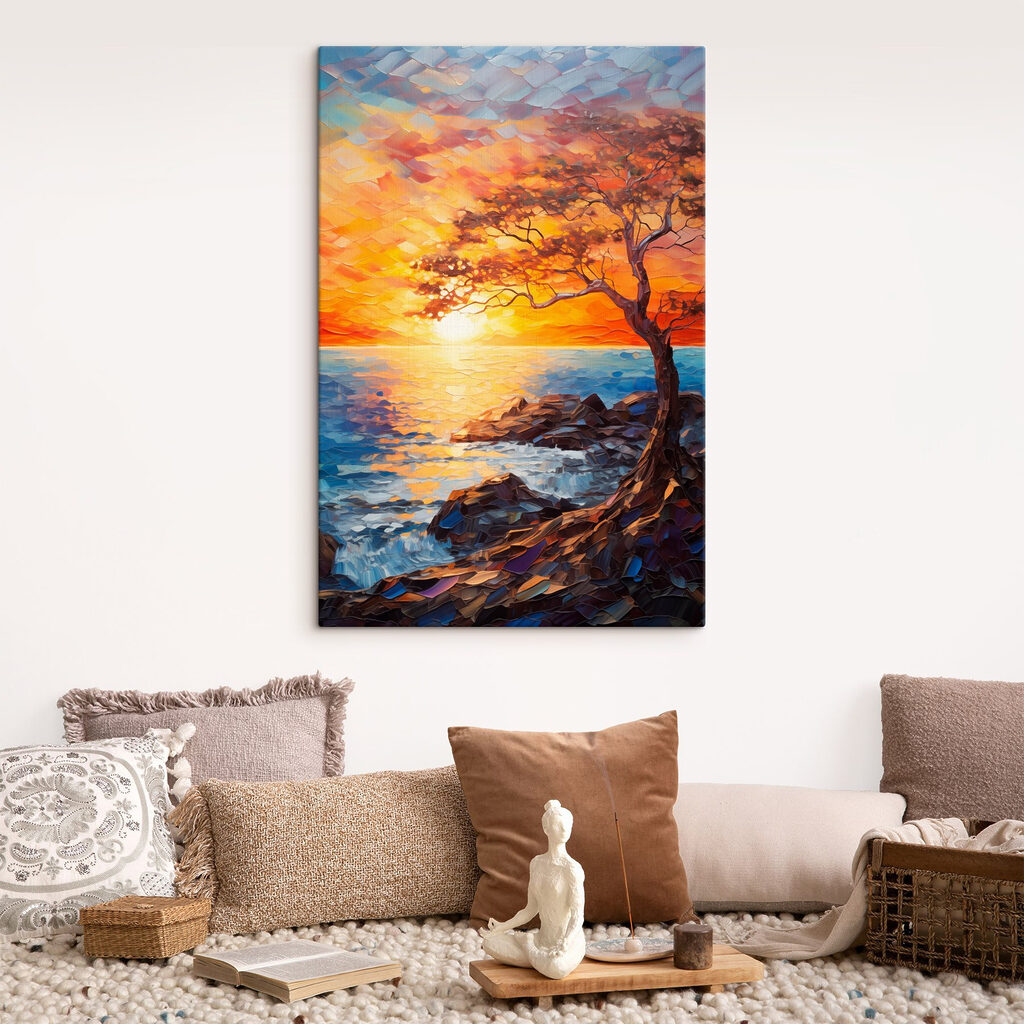 Tree on a rocky shore with a sunset behind it