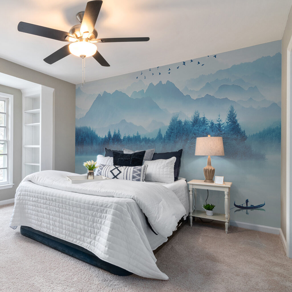 Person in a boat on a lake with birds flying in the sky