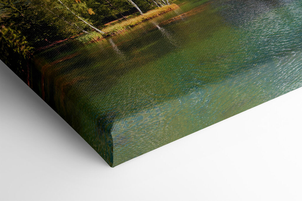 A lake surrounded by trees and mountains A lake surrounded by trees and mountains