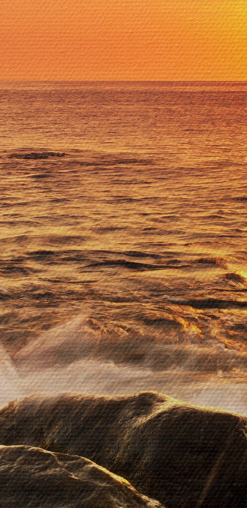 A sunset over a rocky beach