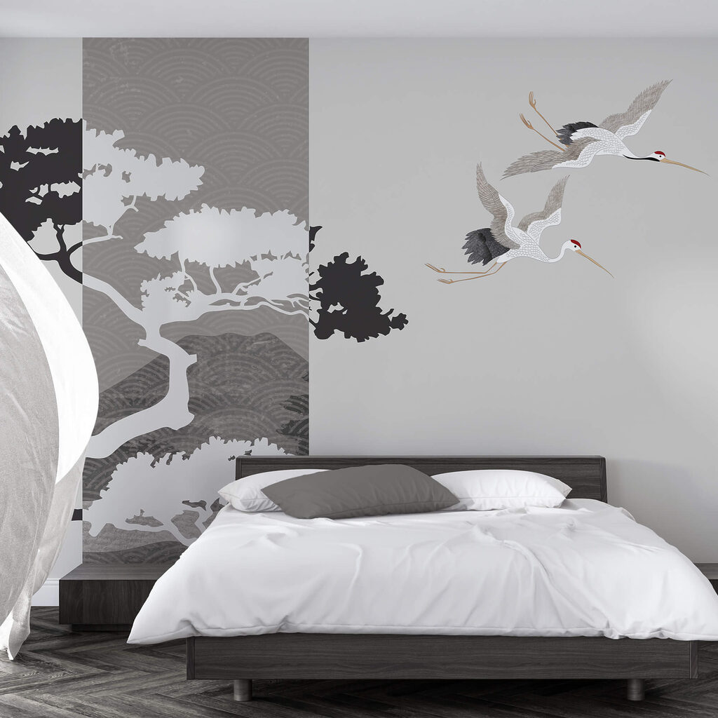 Pár žeriavov letiacich vedľa stromu