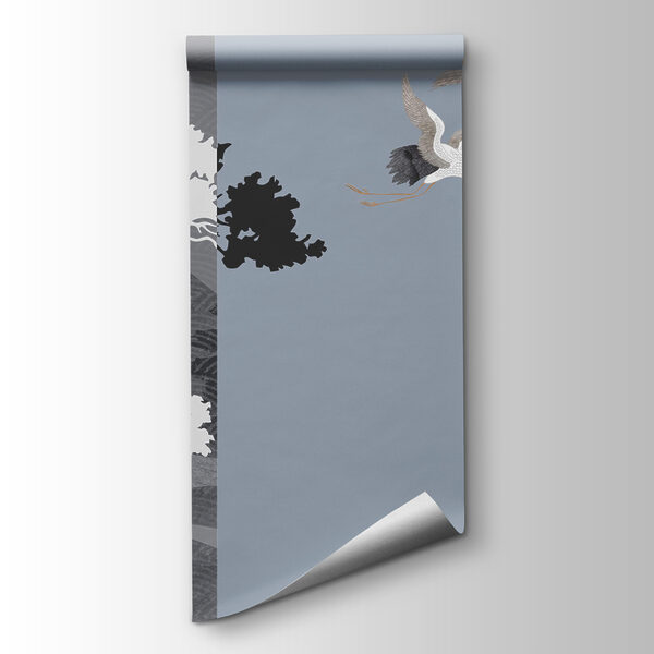 Couple of cranes flying next to a tree