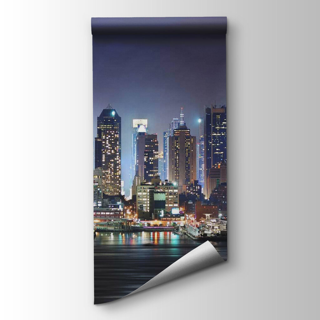 City skyline at night with lights reflecting on water