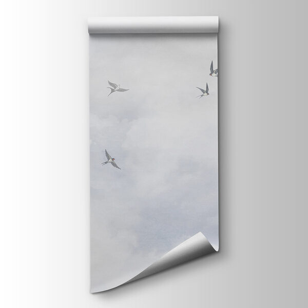 A group of birds flying in the sky