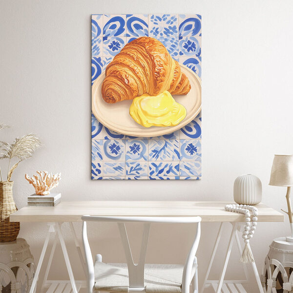 Croissant and a yellow liquid on a plate