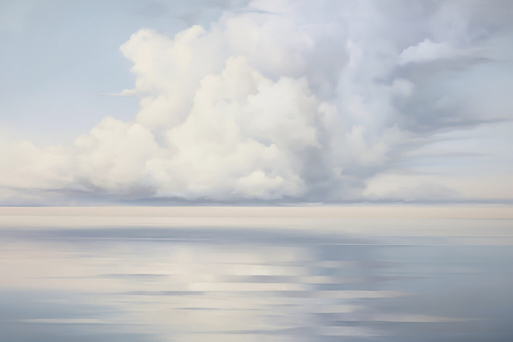 Large body of water with clouds in the sky